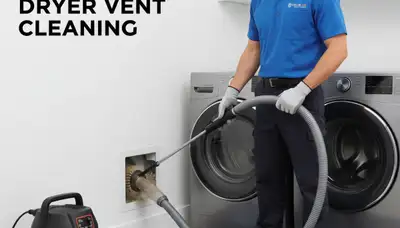 Technician cleaning residential dryer vent in Philadelphia PA for Five Star Cooling maintenance service